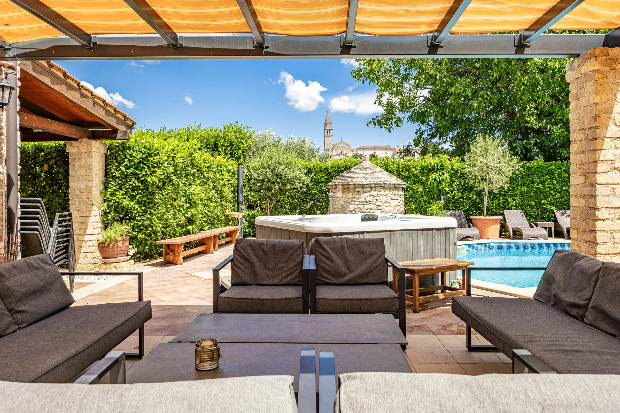 Sun loungers lined up along the long edge of the heated pool