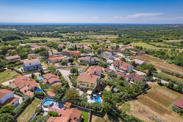 Višnjan seen from the air, its bell tower above the village rooftops