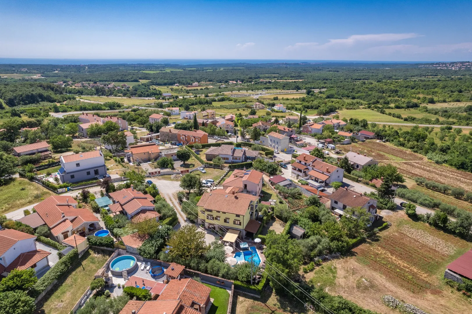 Višnjan from above — red rooftops and gardens stretching towards the horizon