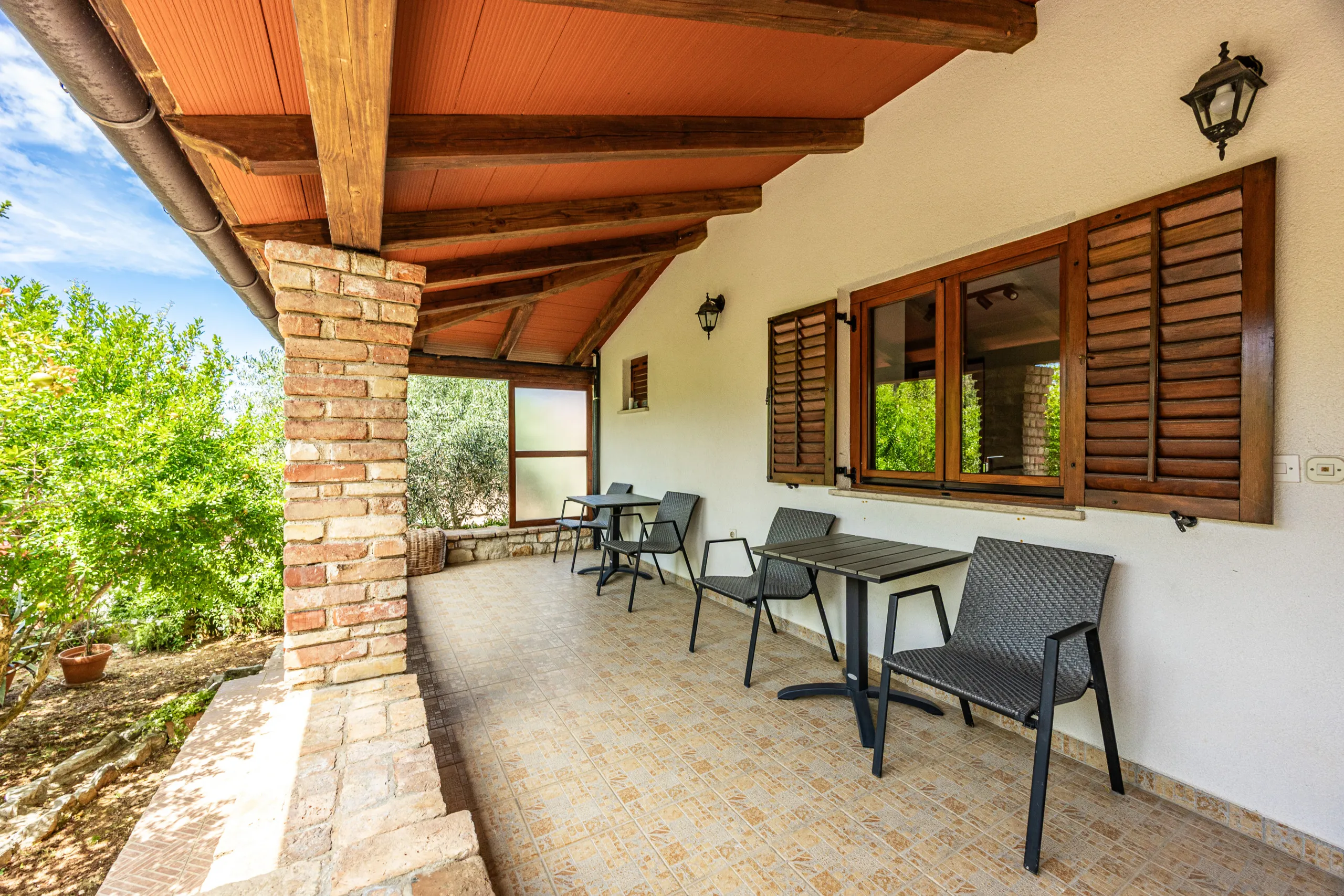 Seating in the shade of the covered stone terrace