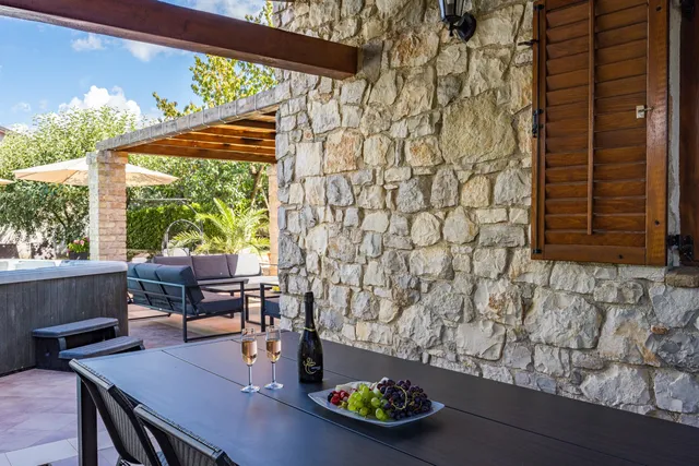 The long dining table on the covered terrace, set for a group meal