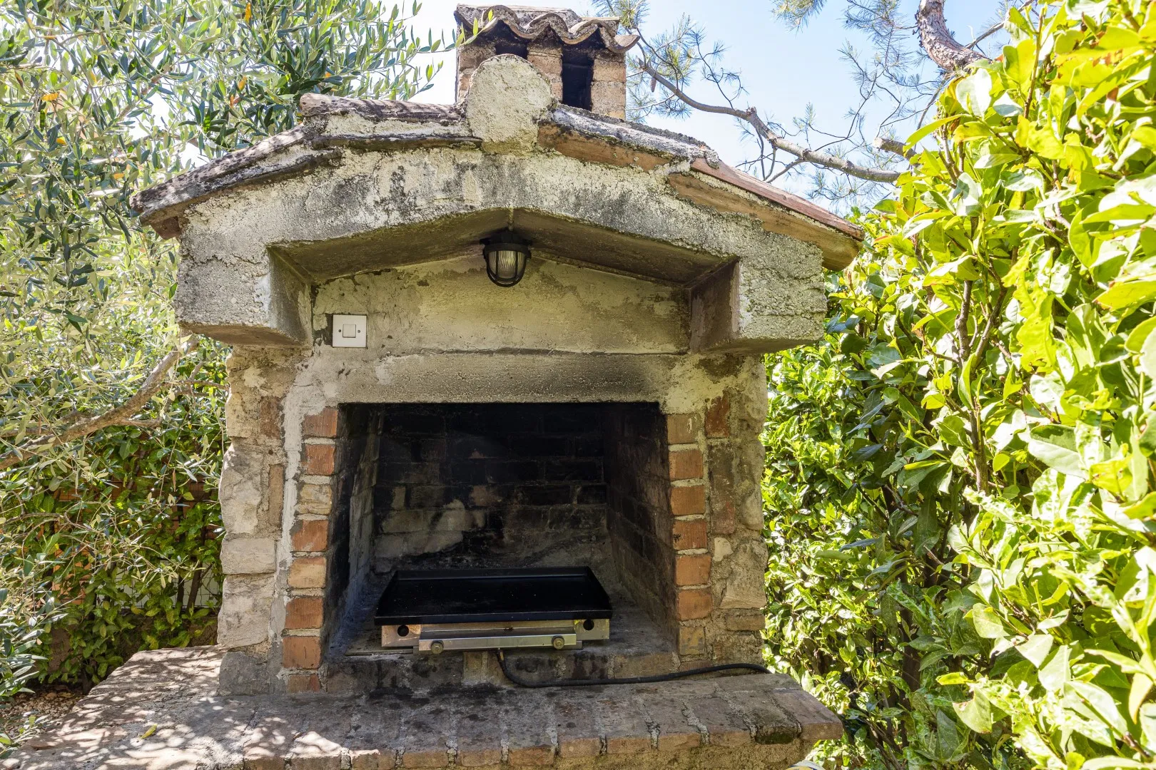 The stone-built outdoor fireplace and barbecue