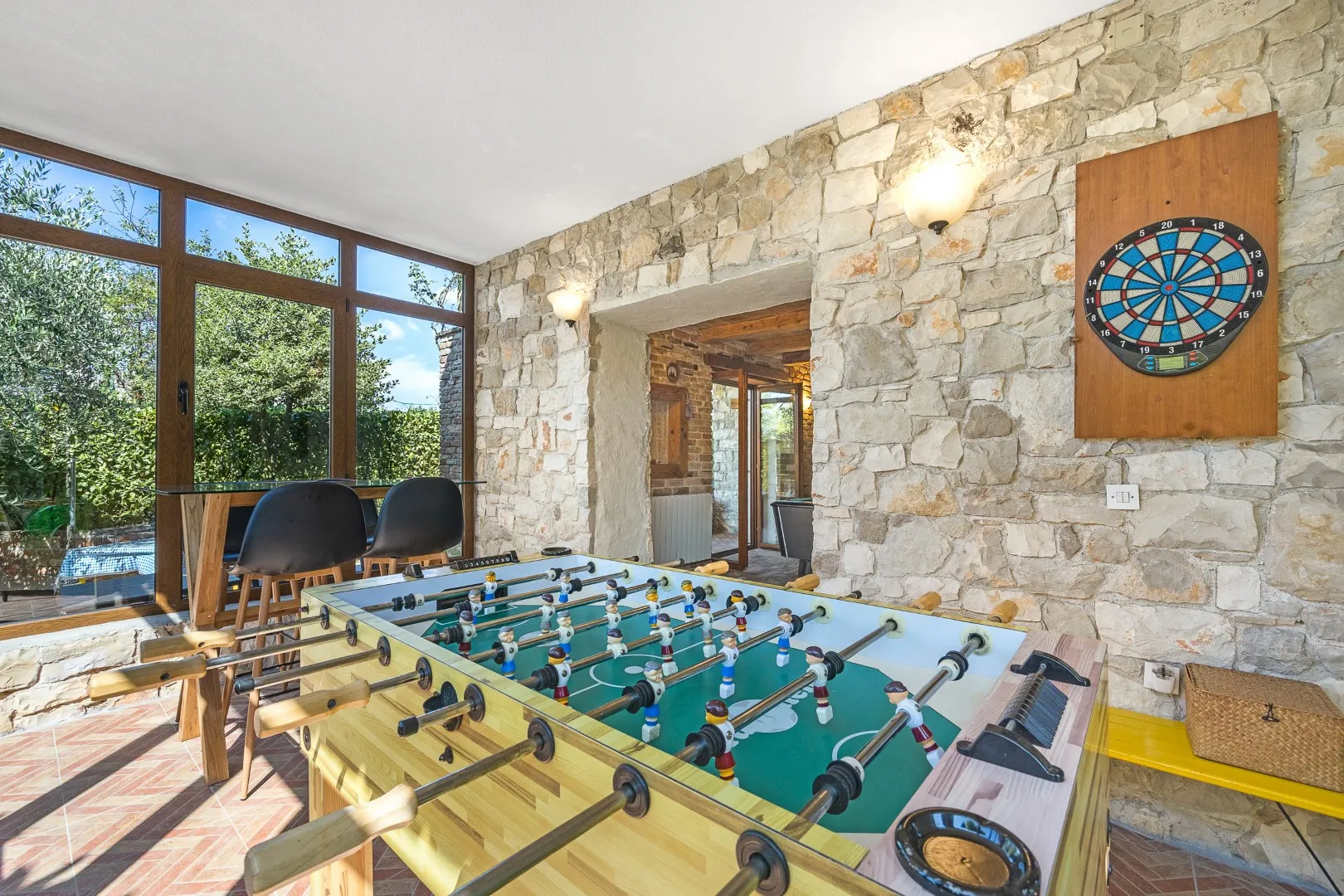 The table football and dartboard in the games room