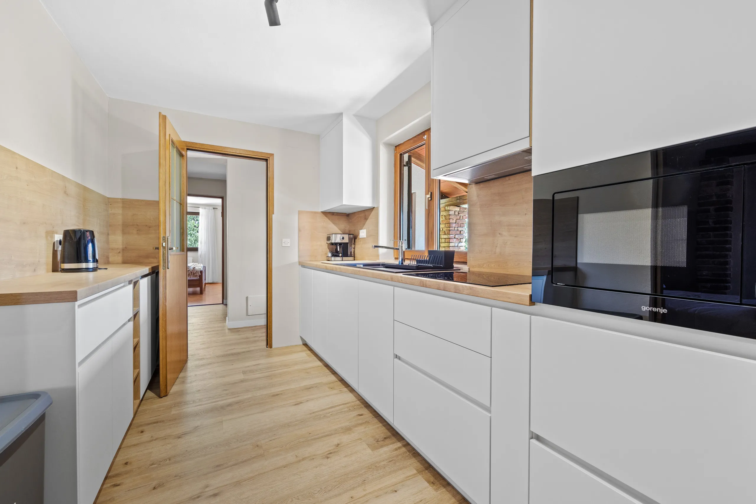 The run of white kitchen units, hob and extractor